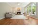 Inviting living room features a fireplace, large windows, hardwood floors, and comfortable seating at 510 Morning Mist Ct, Alpharetta, GA 30022