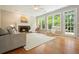 Bright and inviting living room with a fireplace, hardwood floors, large windows, and comfortable furniture at 510 Morning Mist Ct, Alpharetta, GA 30022