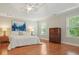 Spacious main bedroom with hardwood floors, large windows, and tray ceiling at 510 Morning Mist Ct, Alpharetta, GA 30022