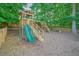 Backyard wooden playground with a slide, swing set, and picnic table offers fun and recreation at 510 Morning Mist Ct, Alpharetta, GA 30022