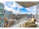 Balcony with seating overlooking city skyline and tall buildings under a bright sky at 943 Peachtree Ne St # 1708, Atlanta, GA 30309