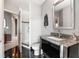Sleek bathroom features a glass shower, granite countertop, stainless steel sink and black tile floors at 943 Peachtree Ne St # 1708, Atlanta, GA 30309