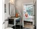 Bathroom featuring granite countertop and steel sink with views to bedroom and city at 943 Peachtree Ne St # 1708, Atlanta, GA 30309
