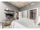 Bedroom featuring concrete ceiling, mounted shelving and TV, two closets, and ensuite bathroom at 943 Peachtree Ne St # 1708, Atlanta, GA 30309