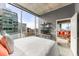 Bright bedroom with expansive windows showcasing city skyline and a cozy living space at 943 Peachtree Ne St # 1708, Atlanta, GA 30309