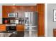 Kitchen area featuring stainless appliances, wood cabinets, and a tile backsplash at 943 Peachtree Ne St # 1708, Atlanta, GA 30309