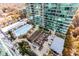 Elevated aerial view of a sparkling pool and outdoor lounge area surrounded by lush landscaping and towering building at 943 Peachtree Ne St # 1708, Atlanta, GA 30309