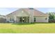 Spacious backyard view showing the home's exterior, covered patio, and large grassy area at 127 Autumn Run Pl, Villa Rica, GA 30180