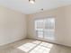 A sunlit bedroom with neutral walls, carpet, and a window with blinds at 127 Autumn Run Pl, Villa Rica, GA 30180