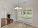 Bright dining room with hardwood floors, large windows, wainscoting, and elegant chandelier at 127 Autumn Run Pl, Villa Rica, GA 30180