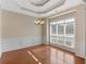 Bright dining room with hardwood floors, large windows, wainscoting, and elegant chandelier at 127 Autumn Run Pl, Villa Rica, GA 30180