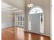 Bright foyer boasts gleaming hardwood floors, a tray ceiling, elegant lighting, and arched entryways at 127 Autumn Run Pl, Villa Rica, GA 30180