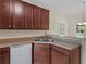 This kitchen features dark cabinets, neutral countertops, and stainless steel sink at 127 Autumn Run Pl, Villa Rica, GA 30180