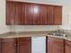 Kitchen features dark cabinets, neutral countertops, and stainless steel sink at 127 Autumn Run Pl, Villa Rica, GA 30180