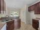 The kitchen features neutral countertops, a stainless steel sink, and a bright window at 127 Autumn Run Pl, Villa Rica, GA 30180