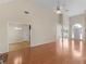 Open-concept living area with hardwood floors, fireplace, and views to the dining room and foyer at 127 Autumn Run Pl, Villa Rica, GA 30180