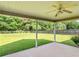Covered patio overlooking a large, fenced backyard with mature trees and a well-maintained lawn at 127 Autumn Run Pl, Villa Rica, GA 30180