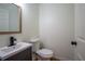 Cozy bathroom with a wood-trimmed mirror, sleek vanity, and a modern toilet at 1342 Carter Rd, Decatur, GA 30030