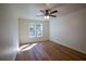 Bedroom features hardwood floors, a ceiling fan, and ample natural light from the large window at 1342 Carter Rd, Decatur, GA 30030