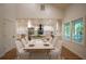 Elegant dining room with a spacious table, white chairs, and ample natural light, perfect for gatherings at 1342 Carter Rd, Decatur, GA 30030