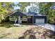 Charming home with blue siding, white trim, a cozy front porch, and a one car garage at 1342 Carter Rd, Decatur, GA 30030