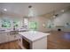 Bright open concept kitchen features hardwood floors, stainless appliances, and an island with quartz countertops at 1342 Carter Rd, Decatur, GA 30030