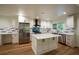 Bright kitchen features white cabinetry, stainless steel appliances and a center island with quartz countertops at 1342 Carter Rd, Decatur, GA 30030