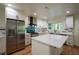 Bright kitchen features an island, white cabinets, stainless appliances and subway tile backsplash at 1342 Carter Rd, Decatur, GA 30030