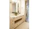 Bathroom with a marble countertop, tiled floor, vanity, and a view into a walk-in closet at 1820 Peachtree Nw St # 309, Atlanta, GA 30309