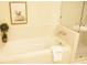 Bright bathroom featuring a soaking tub, tiled walls, glass shower, and whimsical elephant artwork at 1820 Peachtree Nw St # 309, Atlanta, GA 30309