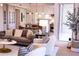 Sunlit living room with stylish decor, plush sofa, and open floor plan leading to a modern kitchen and bright outdoor space at 1820 Peachtree Nw St # 309, Atlanta, GA 30309