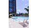 Exterior shot of a clear blue swimming pool with lounge chairs and a building in the background at 1820 Peachtree Nw St # 309, Atlanta, GA 30309