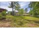 Lush backyard with mature trees and a wooden deck at 2636 Flagstone Se Dr, Atlanta, GA 30316
