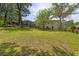 Spacious backyard featuring mature trees, lush green grass, and a charming wooden deck at 2636 Flagstone Se Dr, Atlanta, GA 30316