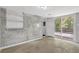 View of the finished basement showcasing exposed brick and a sliding glass door to the backyard deck at 2636 Flagstone Se Dr, Atlanta, GA 30316