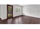 An empty bedroom has hardwood floors, a window, and a front door at 2636 Flagstone Se Dr, Atlanta, GA 30316