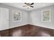 A bedroom featuring two windows, hardwood floors, and a ceiling fan at 2636 Flagstone Se Dr, Atlanta, GA 30316