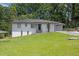 Charming single-story home with updated exterior, well-manicured lawn and an attached garage at 2636 Flagstone Se Dr, Atlanta, GA 30316