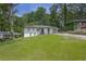 A well-kept single-story home with a lush front yard and a beautiful, dark shingled roof at 2636 Flagstone Se Dr, Atlanta, GA 30316