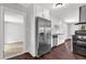Bright kitchen featuring stainless steel appliances, dark hardwood floors, and white cabinets at 2636 Flagstone Se Dr, Atlanta, GA 30316