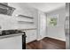 Bright kitchen featuring stainless steel appliances, dark hardwood floors, and white cabinets at 2636 Flagstone Se Dr, Atlanta, GA 30316