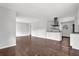 Open-concept living room with dark hardwood floors and modern kitchen at 2636 Flagstone Se Dr, Atlanta, GA 30316