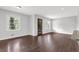 Open-concept living room with dark hardwood floors, large windows, and great natural light at 2636 Flagstone Se Dr, Atlanta, GA 30316