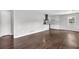 Open-concept living space with hardwood floors and white cabinets in the kitchen at 2636 Flagstone Se Dr, Atlanta, GA 30316