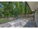 Outdoor patio with wood railing and lush green trees beyond at 2636 Flagstone Se Dr, Atlanta, GA 30316