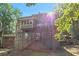 Back exterior of a large home, featuring a multi-level deck in a wooded setting at 3860 Overlake Dr, Cumming, GA 30041