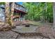 Secluded backyard with stone patio and fire pit, perfect for outdoor entertaining and enjoying nature at 3860 Overlake Dr, Cumming, GA 30041