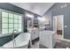This bright primary bathroom features double vanity sinks, a makeup station, and a luxurious soaking tub at 3860 Overlake Dr, Cumming, GA 30041