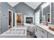 This primary bathroom features a glass shower, soaking tub, vanity, and makeup station at 3860 Overlake Dr, Cumming, GA 30041