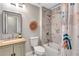Bright bathroom featuring a stylish vanity, toilet, and shower with marbled tile at 3860 Overlake Dr, Cumming, GA 30041